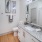 a bathroom with a sink mirror and toilet