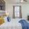 a bedroom with a bed and a fan