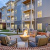 a firepit with chairs around it in a courtyard