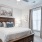 Model bedroom at Arden at Indian Land Apartments in South Carolina, featuring carpeted flooring and windows with blinds.