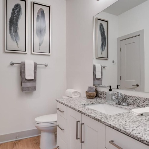 Spacious bathrooms with everything you need a bathroom with a large mirror sink and toilet