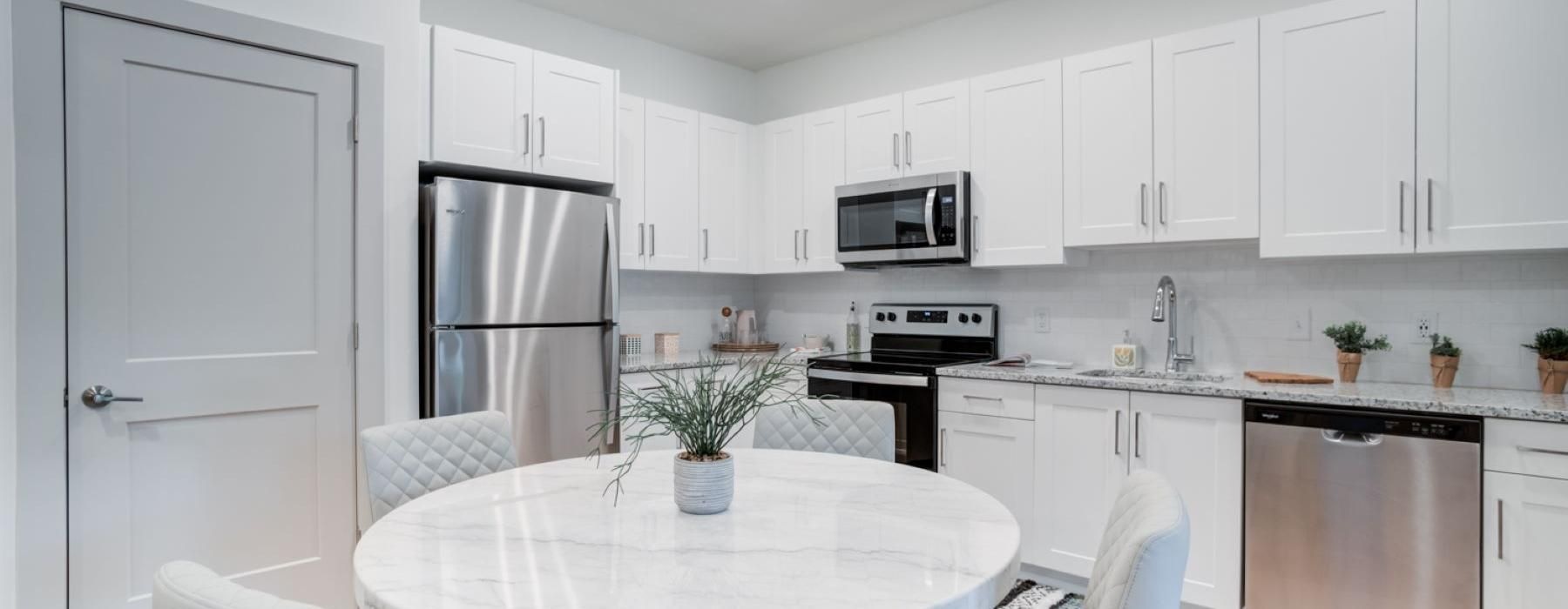 a kitchen with white cabinets