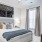 a bedroom with a bed and a fan