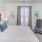 a bedroom with a bed and a chair