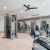 The fitness center at Arden at Indian Land Apartments in South Carolina, featuring wood grain flooring and exercise machines.