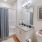 a bathroom with a shower sink mirror and toilet