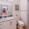 a bathroom with a sink toilet and mirror