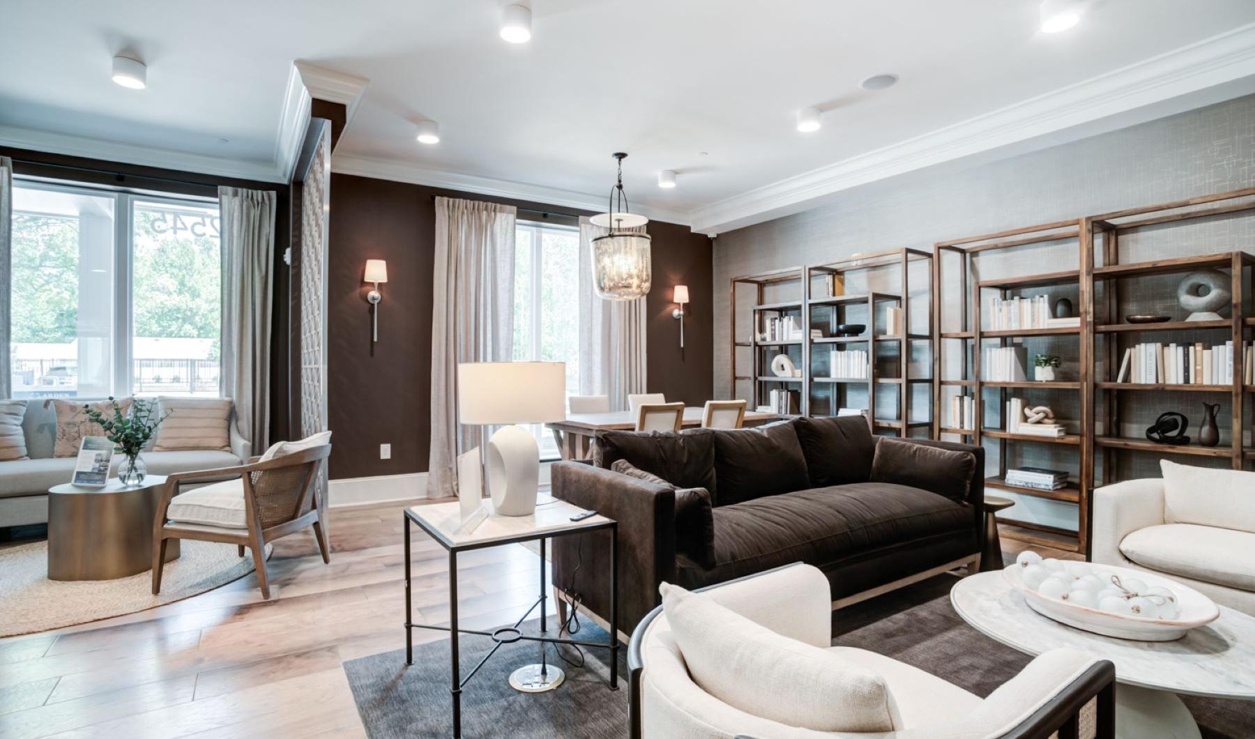 Settle into comfort at Arden at Indian Land  Arden at Indian Land Apartments in South Carolina, featuring wood grain floor paneling and couches.
