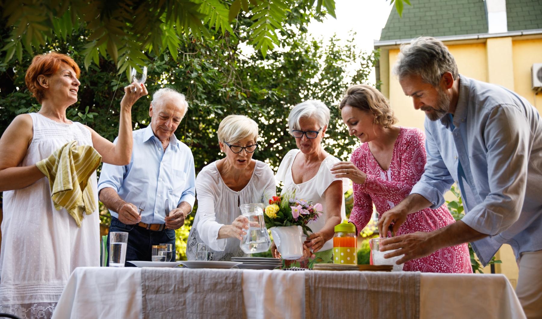 Bustling community with plenty of dining choices a group of people standing around a table with flowers